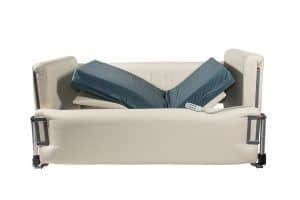 A blue mattress with the head and foot sections raised to make an open V shape. The mattress has four padded sides around it. The head, foot and far side walls are raised high.