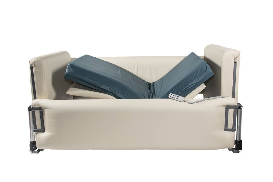 A blue mattress with the head and foot sections raised to make an open V shape. The mattress has four padded sides around it. The head, foot and far side walls are raised high.